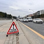 Trafik kontrolü için uyarı tabelası yol kenarında yer alıyor.